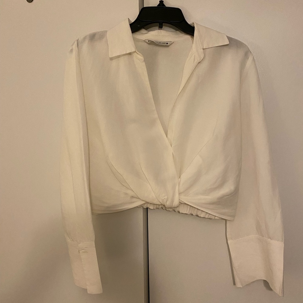 Shirt cropped just above high waist pants